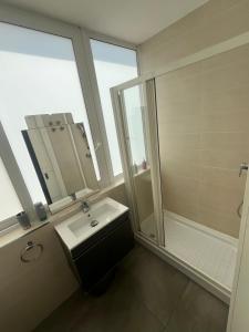 a bathroom with a sink and a shower at 5 Star Residence - Stylish Modern apartments in St Julians in St Julian's +16 photos