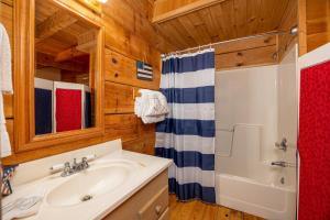 a bathroom with a sink and a shower at Old Glory by American Patriot Getaways in Catlettsburg +17 photos