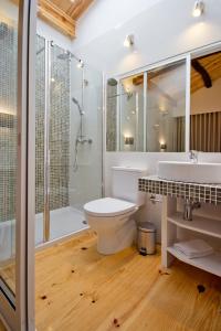 a bathroom with a toilet, tub, sink and shower at MyStay Porto Bolhão in Porto