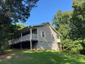 a house with a balcony on the side of it at Ole Bud Cabin by American Patriot Getaways in Walnut Grove