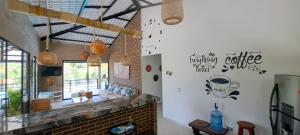 a living room with a fireplace and a brick wall at Villa Jana Casa campestre cerca a Villeta in Quebradanegra