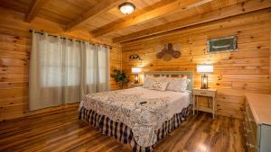 a bedroom with a bed in a log cabin at Panoramic Peak by American Patriot Getaways in Walnut Grove