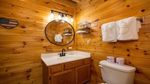 a bathroom with a sink and a toilet and a mirror at Panoramic Peak by American Patriot Getaways in Walnut Grove +32 photos