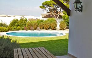 a swimming pool in a yard with two chairs at ST Pool Gardens SESIMBRA,Tranquility Beach 10min in Sesimbra