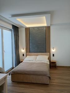 a bedroom with a large bed and a large window at Kaszmirowe Mini Spa in Augustów