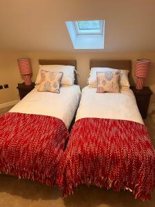 two beds sitting next to each other in a bedroom at St Kitts By the Sea, at Sandgate in Sandgate