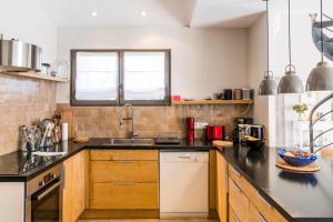 a kitchen with a sink and a counter top at Bastide Blanche Villa with swimming pool and pétanque court in Lourmarin in Lourmarin
