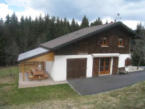 a small wooden house with a table in the yard at Chalet in Ventron near Ski Lift in Ventron