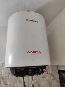 a white appliance sitting on top of a wall at Entire 1BHK Flat Home Stay in Nashik +1 photo