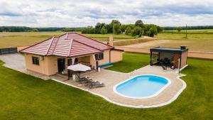 an overhead view of a house with a swimming pool at Holiday House Drava Relax in Pitomača