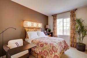 a bedroom with a bed and a table and a window at Single-Story San Bernardino Home with Valley Views! in San Bernardino