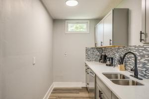 a kitchen with a sink and a window at Less Than 1 Mi to EverBank Stadium Retreat with Yard! in Jacksonville +16 photos