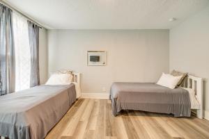 a bedroom with two beds and a window at Less Than 1 Mi to EverBank Stadium Retreat with Yard! in Jacksonville
