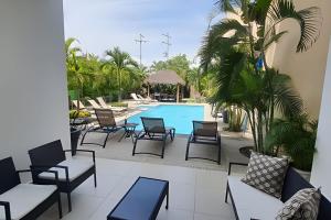 a patio with chairs and a swimming pool at Departamento Hanna #1 Bucerias in Bucerías