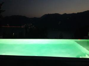 a view of a swimming pool at night at Marone Apartment with Pool in Marone