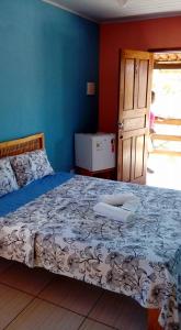 En eller flere senge i et værelse på Pousada Aritibe