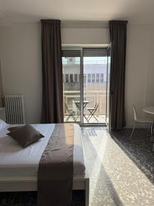 a bedroom with a bed and a view of a patio at Margherita suites - City center in Bari +10 photos
