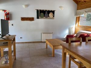 a living room with a couch and a table at BOG Altos de Antilhue - Apart con vista al bosque in Villa La Angostura