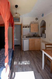 a kitchen with a bed and a table in a room at Ferienzimmer (Stanza) in Fondo Trentino in Fondo