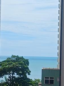 a tall building with a tree in front of it at Tulip in flat SAN martain in Fortaleza