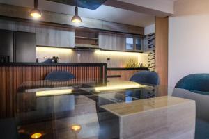 a dining room with a glass table and blue chairs at Ayra Hotel Boutique in Pisac