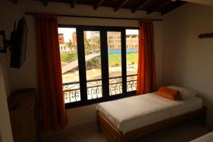a bedroom with a window with a view of a pool at Apartahotel El Horizonte in Guatapé
