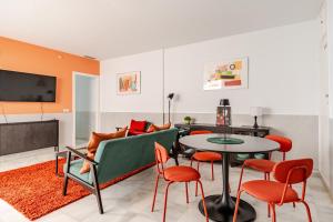 a living room with a couch and a table and chairs at Sofia Luxury Apartment in Seville