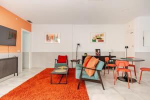a living room with a table and chairs at Sofia Luxury Apartment in Seville