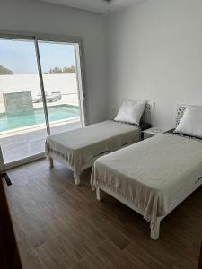 Postel nebo postele na pokoji v ubytování Villa Khadija