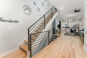 a stairwell in a home with a staircase mural on the wall at Queen City's Den Uptown in Charlotte