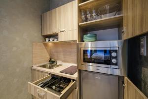 a kitchen with a sink and a microwave at А17 Plovdiv Apartments - Close to University hospitals, Rowing Channel and Mall Plovdiv in Plovdiv