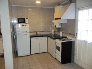 a kitchen with a white refrigerator and a stove at EVA Apartments 3 in San Rafael