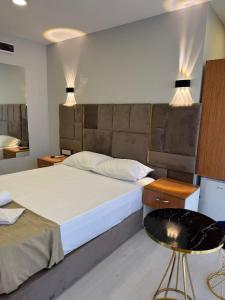 a bedroom with a large bed and a table at Mall Off Palace in Istanbul