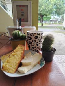 a plate of food with cheese and bread on a table at Apartahotel los cactus in David