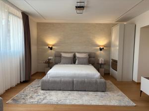 a bedroom with a large bed and a large rug at Vila Palas in Vrnjačka Banja