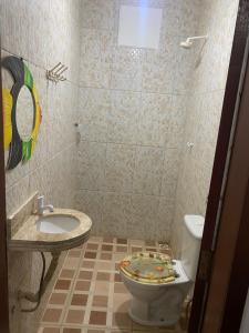 a bathroom with a toilet and a sink at Duplex praia de camarupim in Nísia Floresta +27 photos