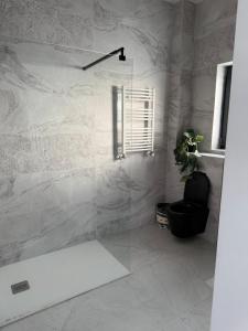 a bathroom with a glass shower with a black chair at Luxury Villa Residence Corbeanca in Corbeanca +61 photos