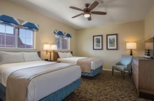 a hotel room with two beds and a ceiling fan at Club Wyndham Branson at The Meadows in Branson