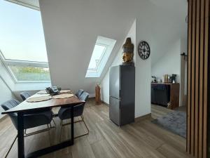 a dining room with a table and a clock on a wall at Ruhige zentrale Ferienwohnung in Wolfhagen