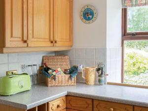 a kitchen counter with a toaster and baskets on it at Middle Lodge in Mintlaw +19 photos