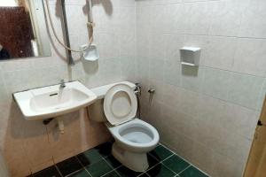 a bathroom with a toilet and a sink at Hotel O Prai Jaya in Perai +18 photos
