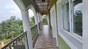 a walkway on a house with windows at Green house heaven in Kribi