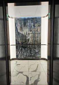 a view through a glass door of a painting at Elegant 2BR & 2BA Retreat in Prime Yorkville, Downtown in Toronto