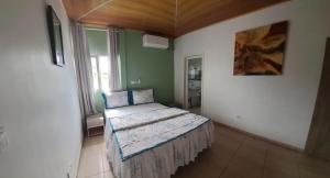a bedroom with a bed in the corner of a room at Green house heaven in Kribi