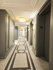 a corridor of an office building with a long hallway at Elegant 2BR & 2BA Retreat in Prime Yorkville, Downtown in Toronto