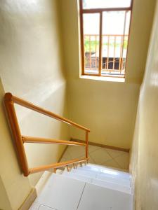 a staircase in a room with a window at Kinyaiya's Sereniry Farmstay 