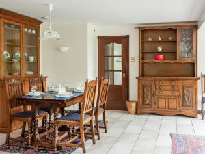 a dining room with a wooden table and chairs at Middle Lodge in Mintlaw