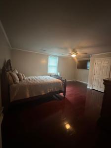 a bedroom with a bed and a ceiling fan at The Russenberger Retreat in Little Rock