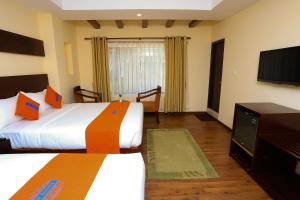 Krevet ili kreveti u jedinici u okviru objekta Hotel Jay Suites