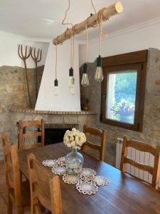 a dining room table with a vase of flowers on it at Campus el abuelo in Denia